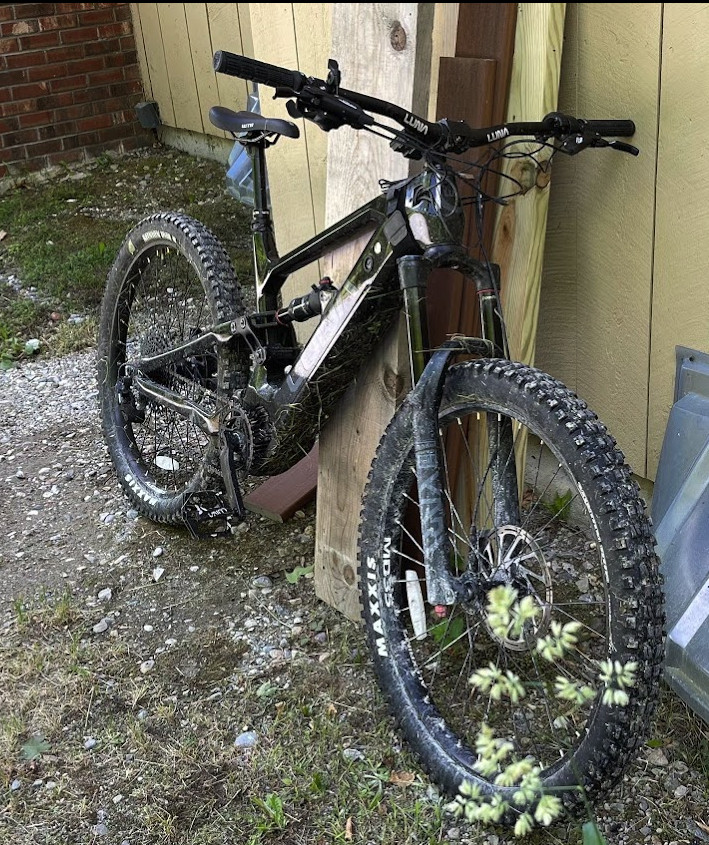 Luna X2 e-bike parked on a rocky trail with natural background.
