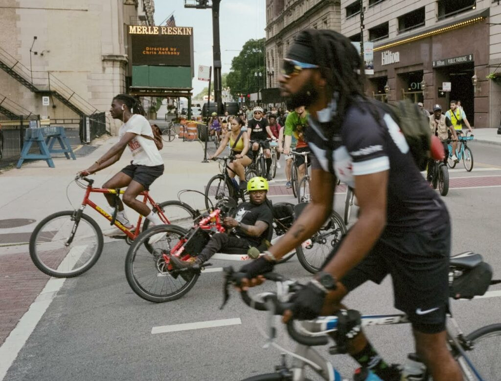 Diverse group of cyclists participate in the Black JoyRide Juneteenth community bike ride in Chicago, promoting unity and joy through crew bikes.