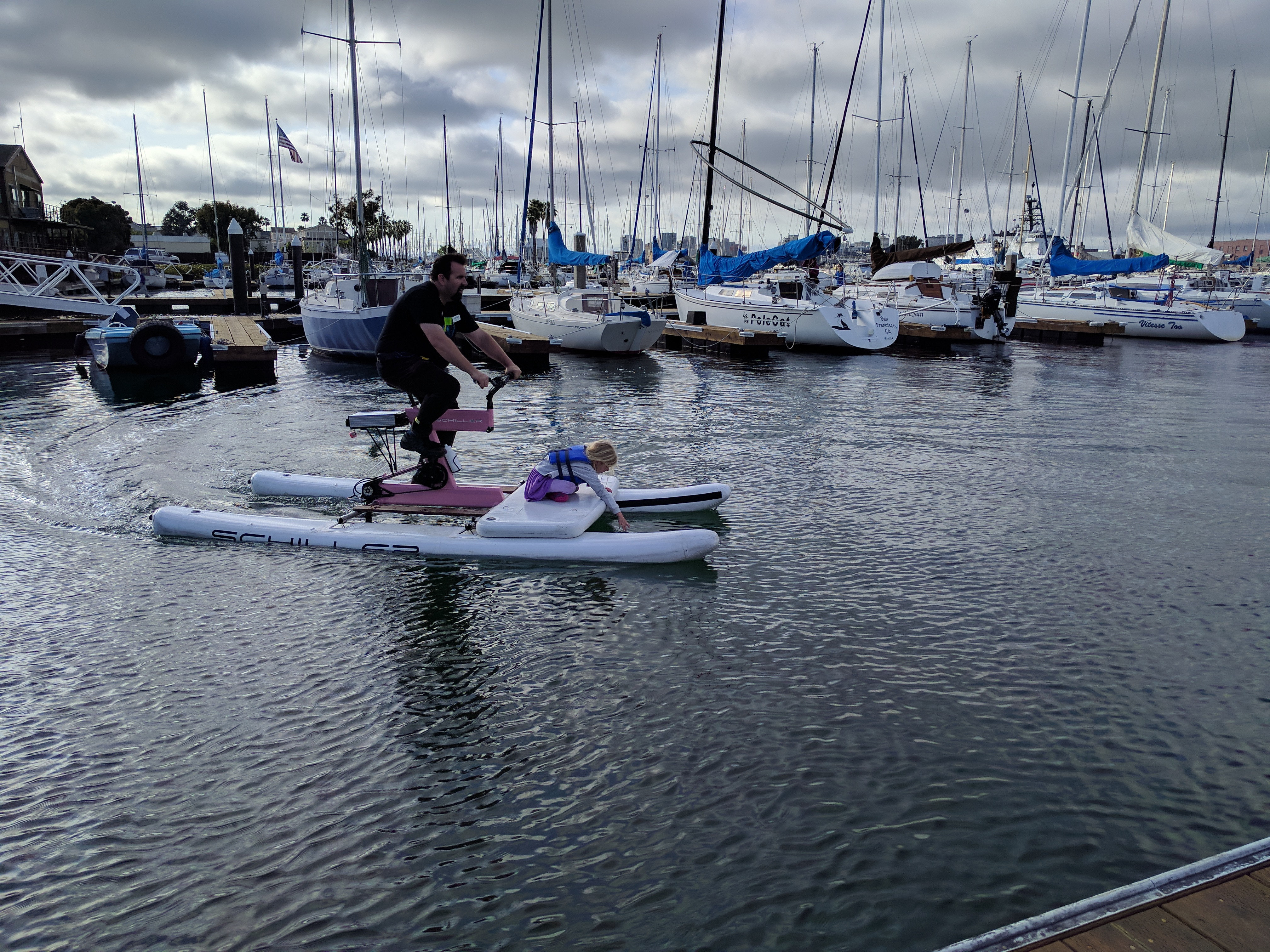 Brian McGuire and his daughter try out water-bikes at Bike Walk Alameda event