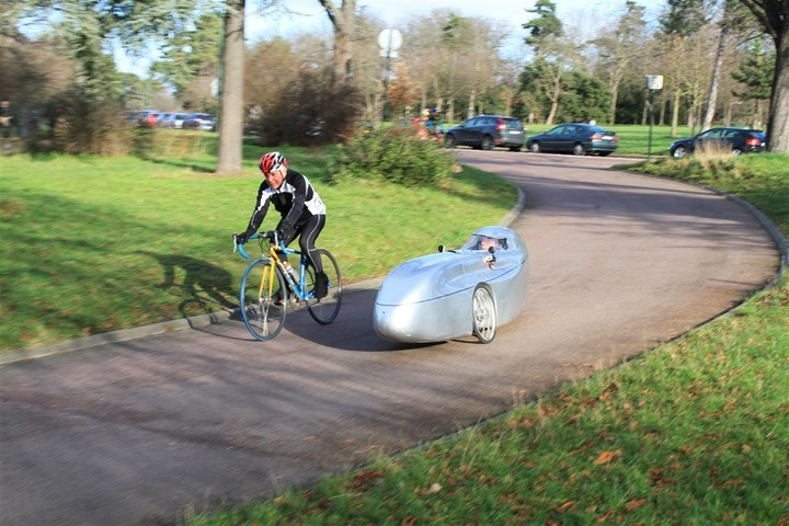 Silver recumbent bike speeding on a corner at Longchamp race track