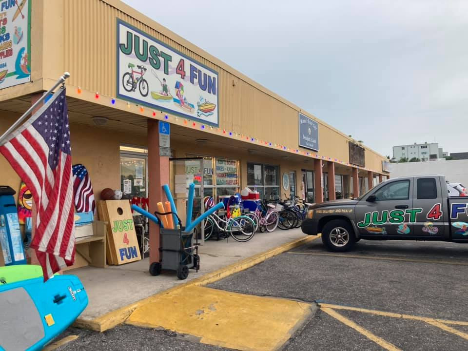 Variety of colorful beach cruiser bikes parked outside Just 4 Fun Beach Rentals, Anna Maria Island