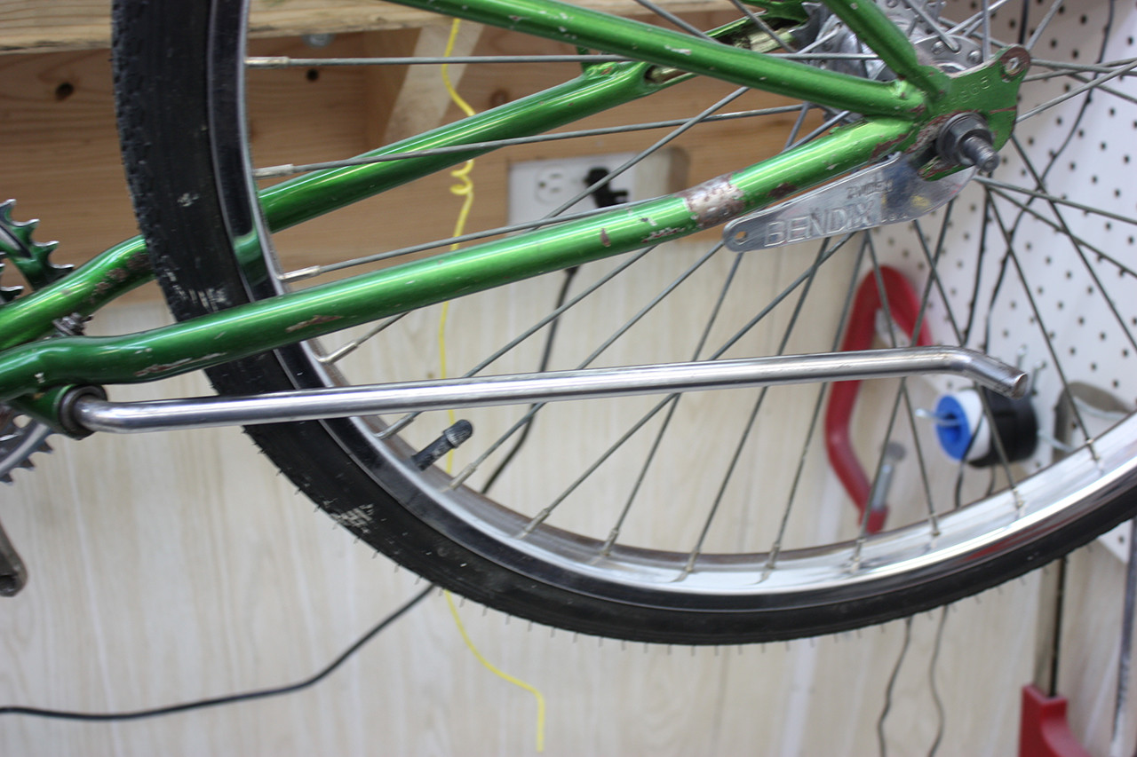 Kickstand of the Steve Schwinn bike after cleaning and polishing, showing the restored condition of a small component.