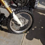 Front wheel unmounting for bike tire replacement