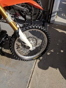 Front wheel unmounting for bike tire replacement