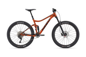 Giant Stance mountain bike in Amber Glow color, showcasing its full suspension trail bike design