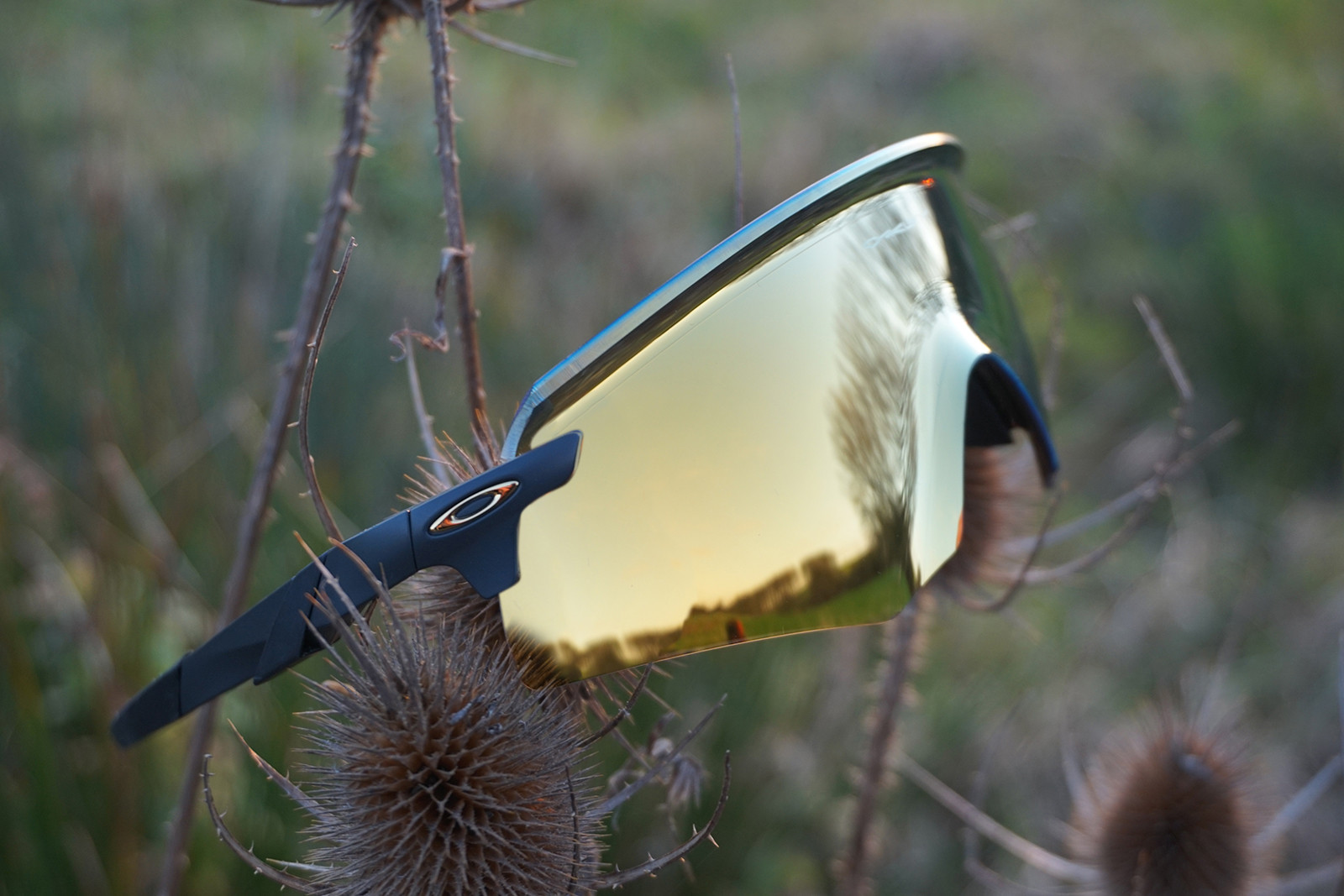 Oakley Encoder sunglasses for road cyclists, designed for seamless integration with cycling helmets and offering a wide field of vision.