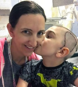Parker and his mother Melissa smiling, showcasing the support system during his recovery and bike riding journey.