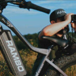 alt text: Rambo electric hunting bike in woodland setting, showcasing its stealth and outdoor readiness.