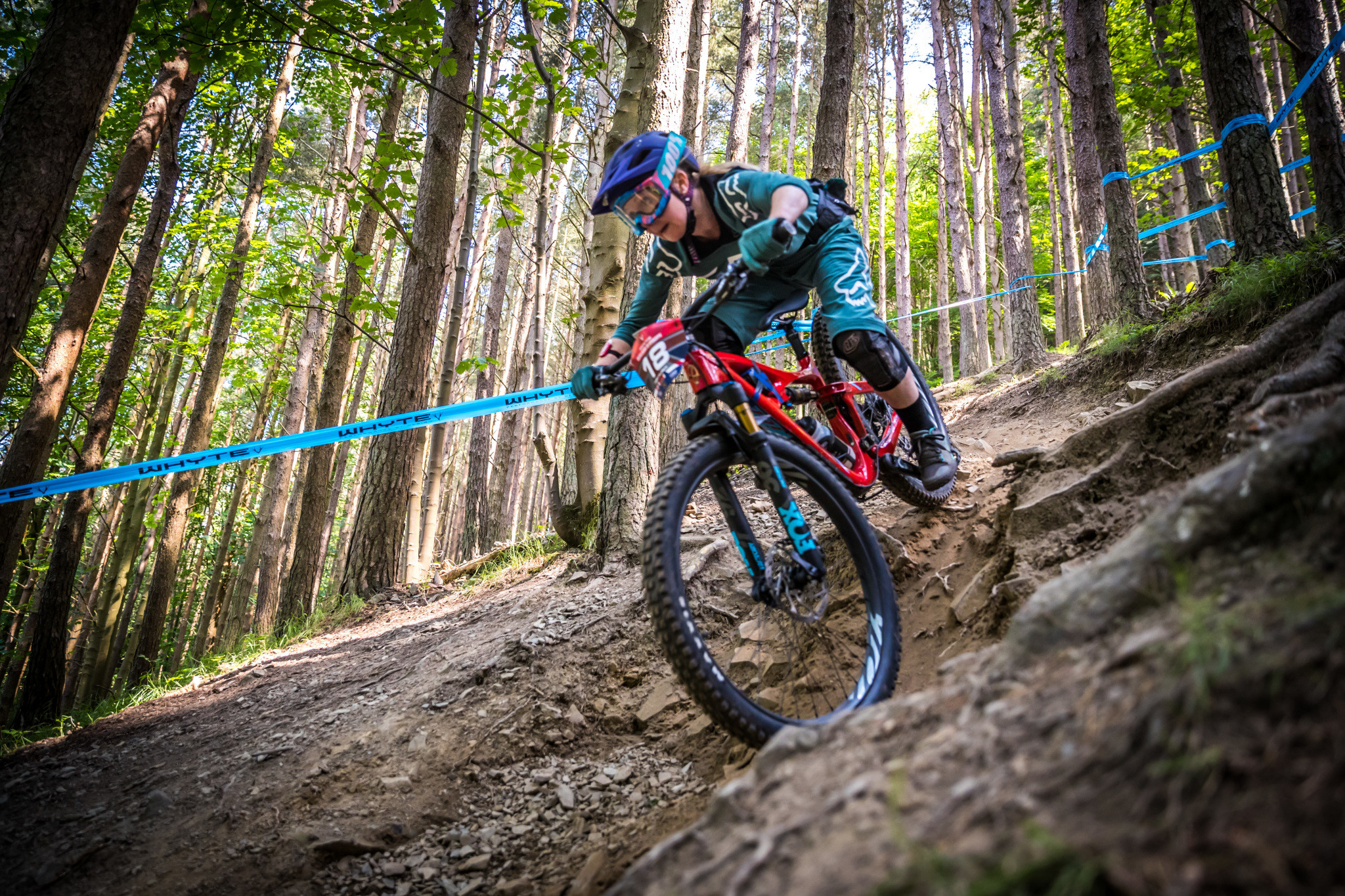 Ibis Mojo 3 rider navigating a berm on a trail