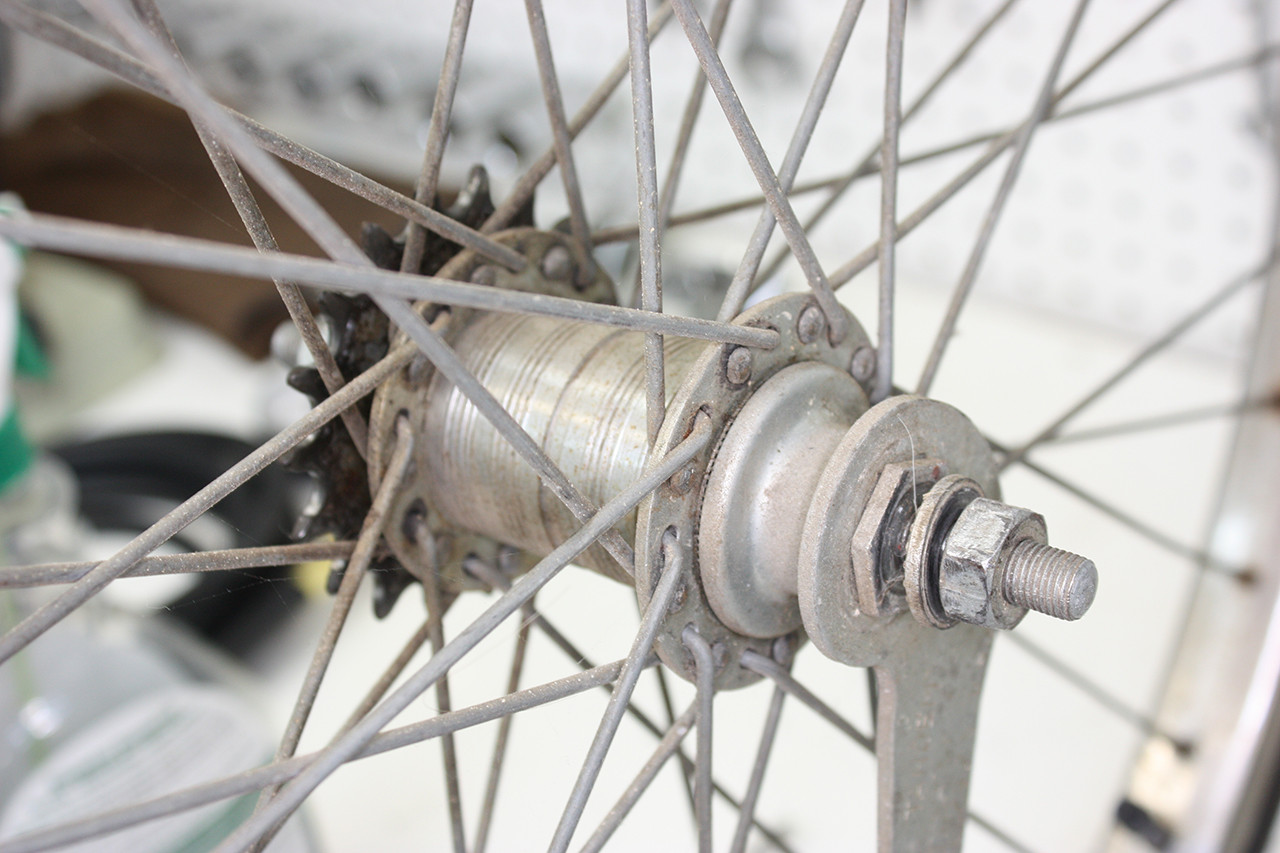 Rear wheel hub brake side of the Steve Schwinn Twinn Tandem before cleaning, showing dirt and old lubricant.