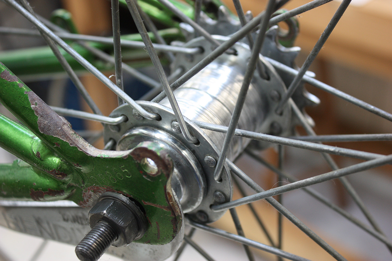 Rear wheel hub and brake of the vintage Schwinn tandem overhauled and polished, showcasing the restoration work.