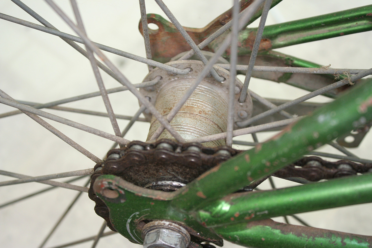 Image showing the rear coaster brake hub of the vintage Schwinn tandem, covered in old grease before overhaul.