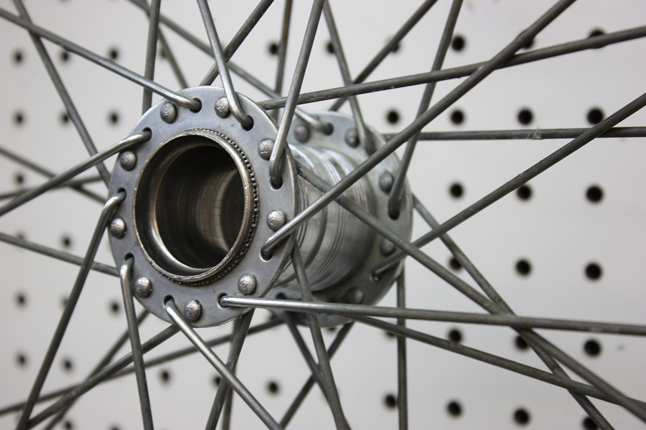 Rear wheel hub of the Steve Schwinn bike cleaned and undergoing initial polishing, showing progress in restoration.