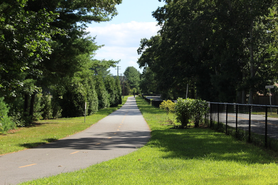 The Quonset Point Bike Path entrance at Calf Pasture Point Beach, Rhode Island, showcasing a beautiful beach and bay scenery