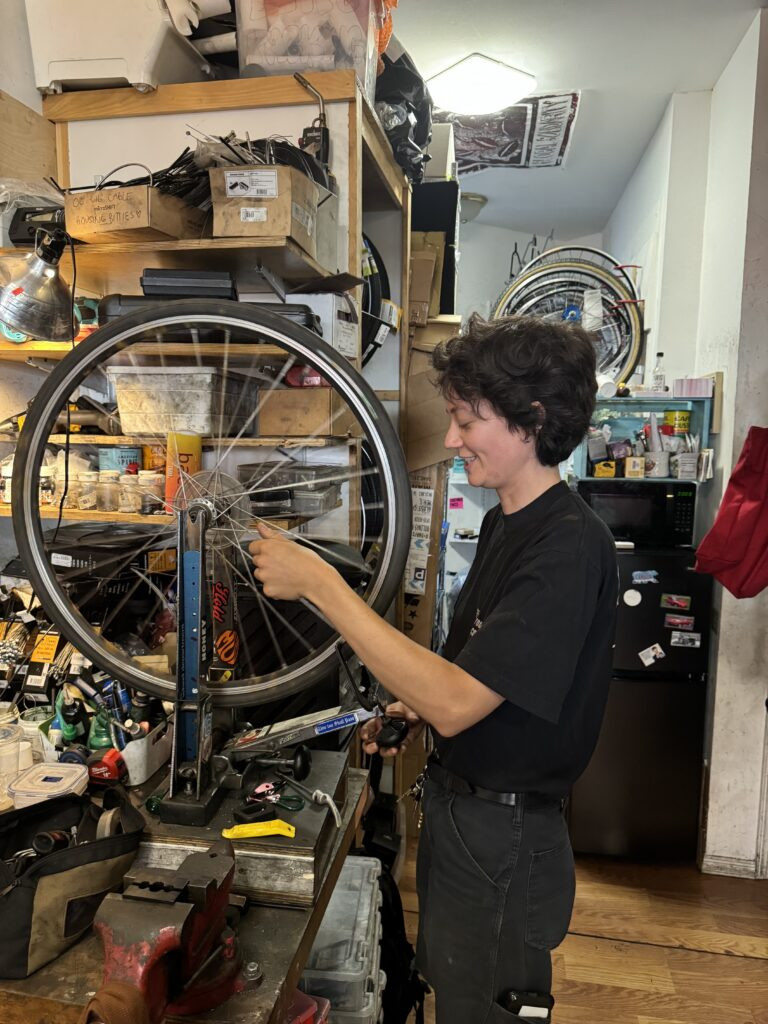 Robin Graven-Milne, the owner of Bike Plant, a community-focused bike shop in Brooklyn, photographed inside their shop.