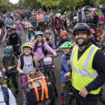 Sam Balto at the front of the bike bus, guiding children and parents on bikes in Portland.