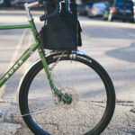 Close-up of the Soma Grand Randonneur's front fork and handlebars, emphasizing the low-trail geometry and elegant design details typical of a classic randonneur bicycle.