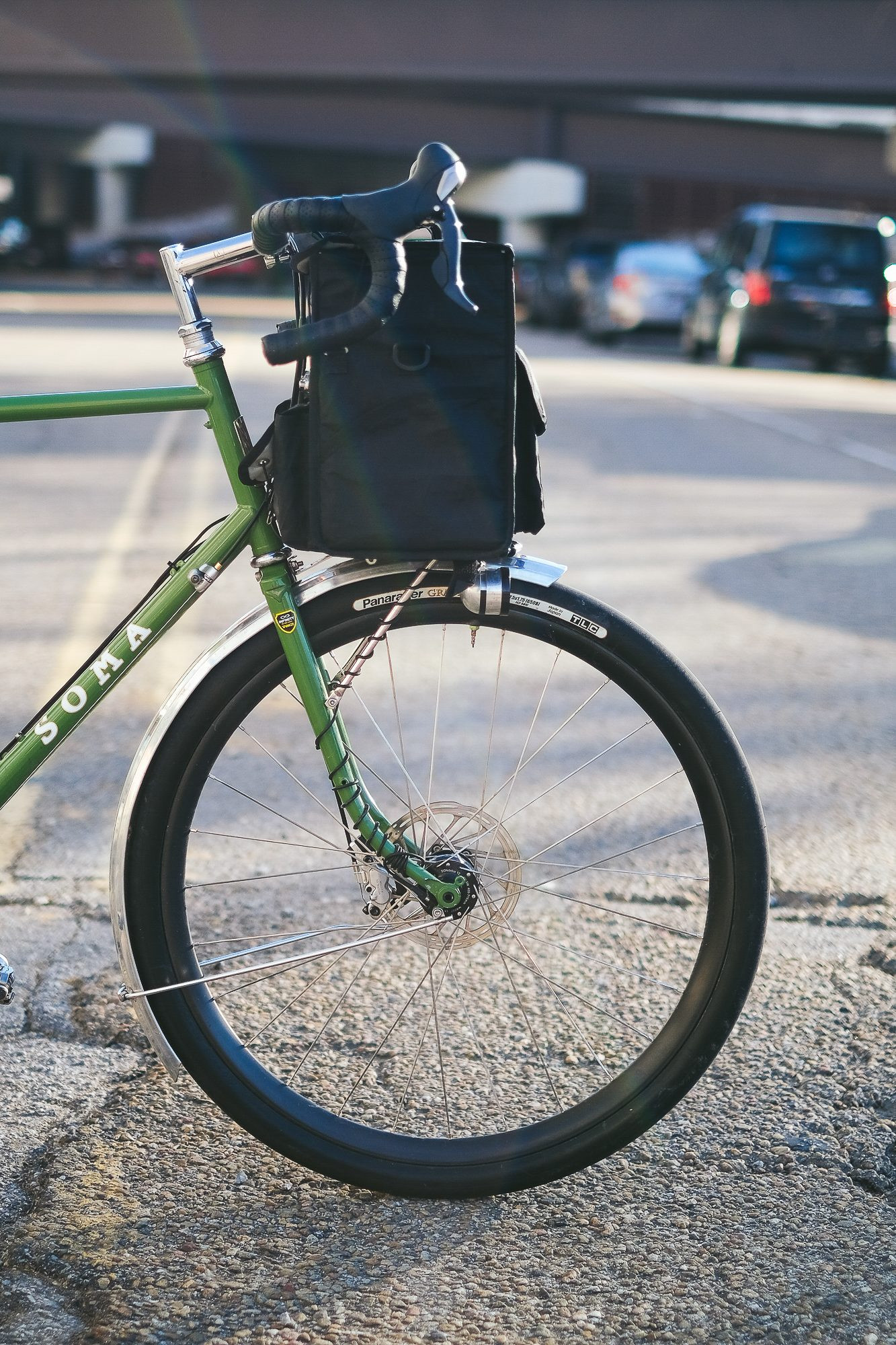 Close-up of the Soma Grand Randonneur's front fork and handlebars, emphasizing the low-trail geometry and elegant design details typical of a classic randonneur bicycle.