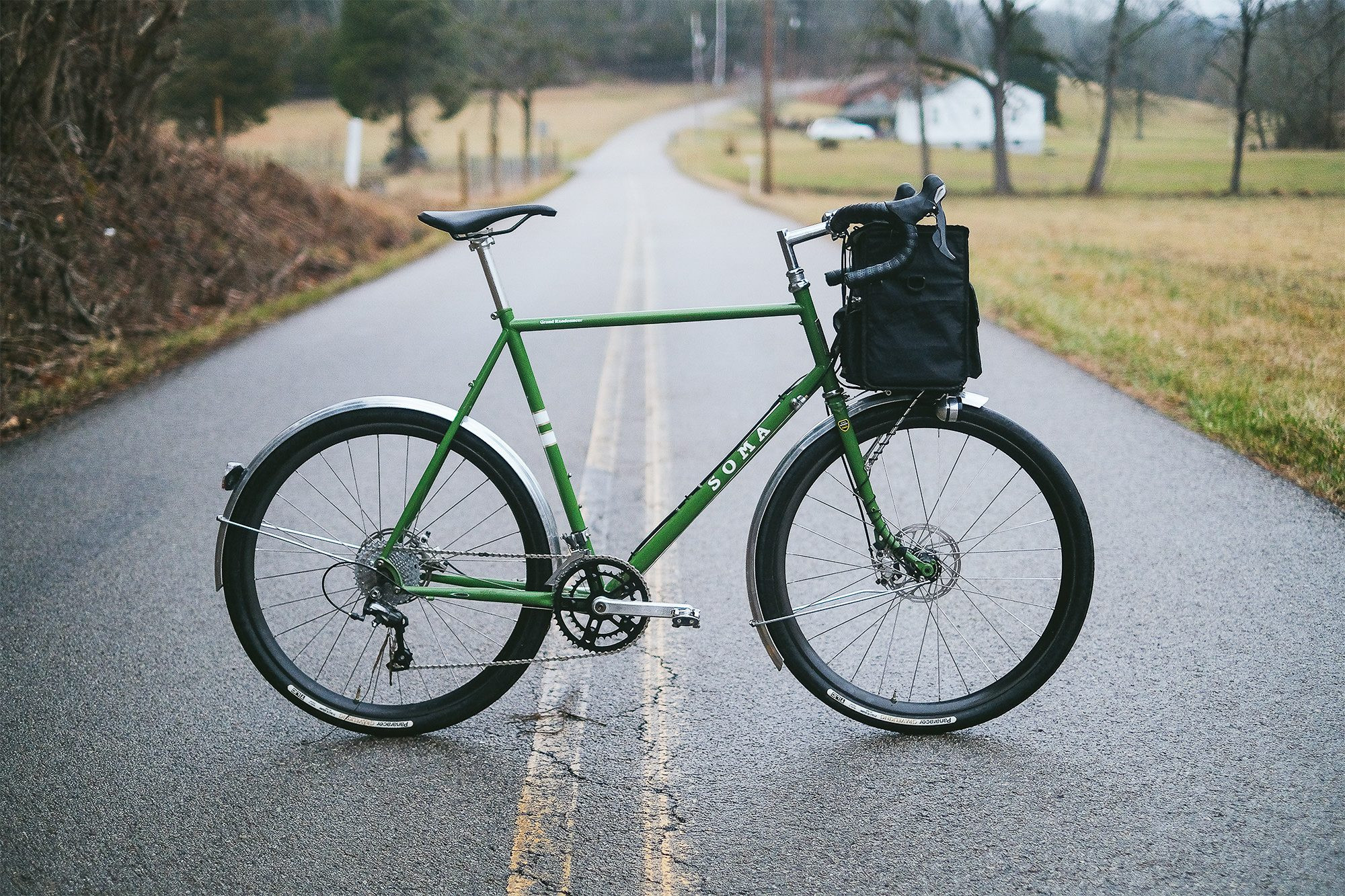 Side profile of the Soma Grand Randonneur in a gravel racing configuration, highlighting the less conventional setup and its limitations for this type of riding, contrasting with its touring and randonneuring strengths.