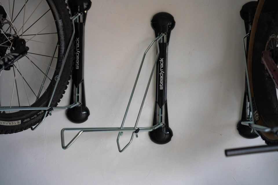 Close-up of a Steadyrack bike rack holding a mountain bike, demonstrating the roll-in and secure grip.