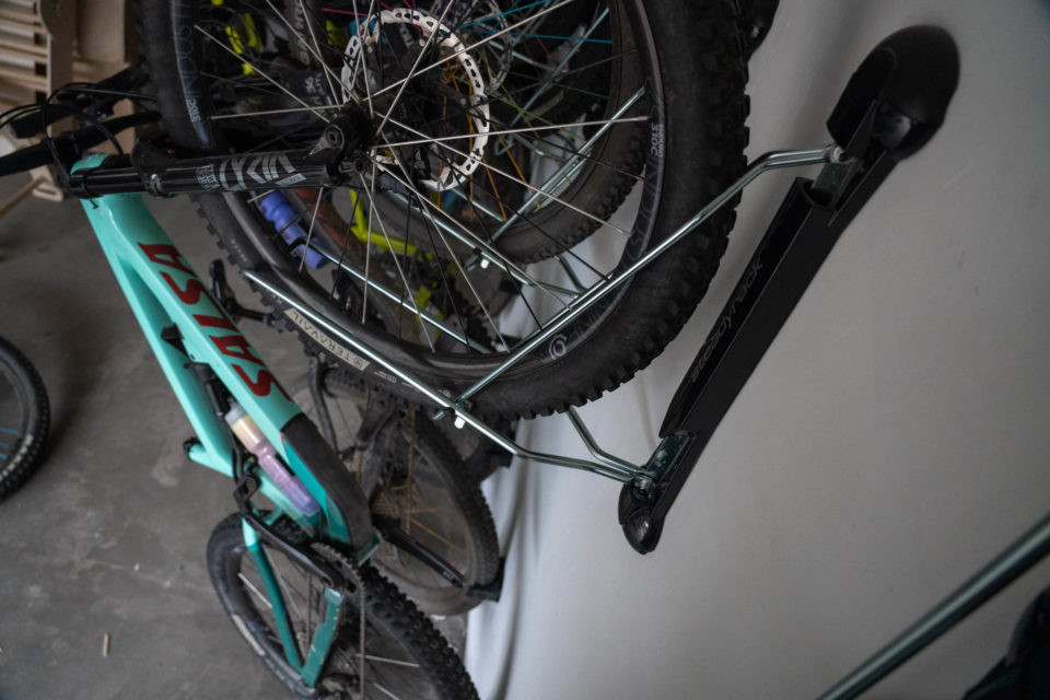 Steadyrack bike racks installed in a garage, showcasing space-saving rotation feature.