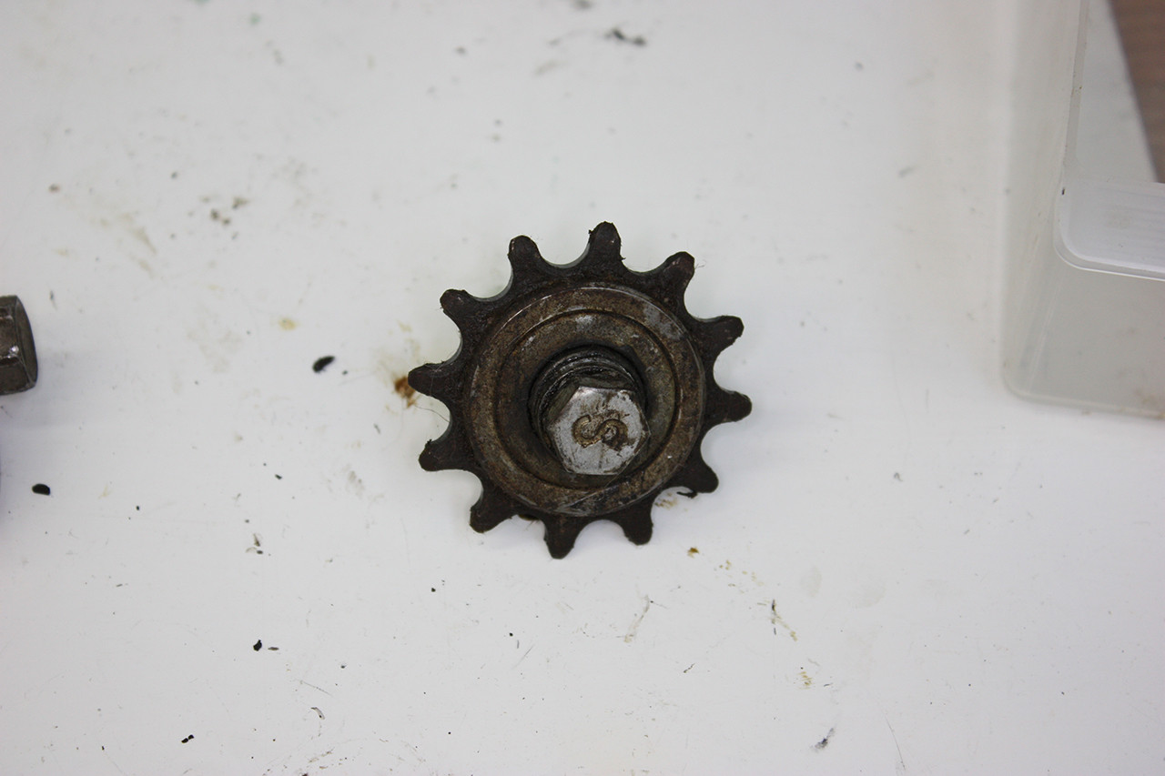 Tension wheel of the Steve Schwinn bike before cleaning, showing dirt and aged lubricant.