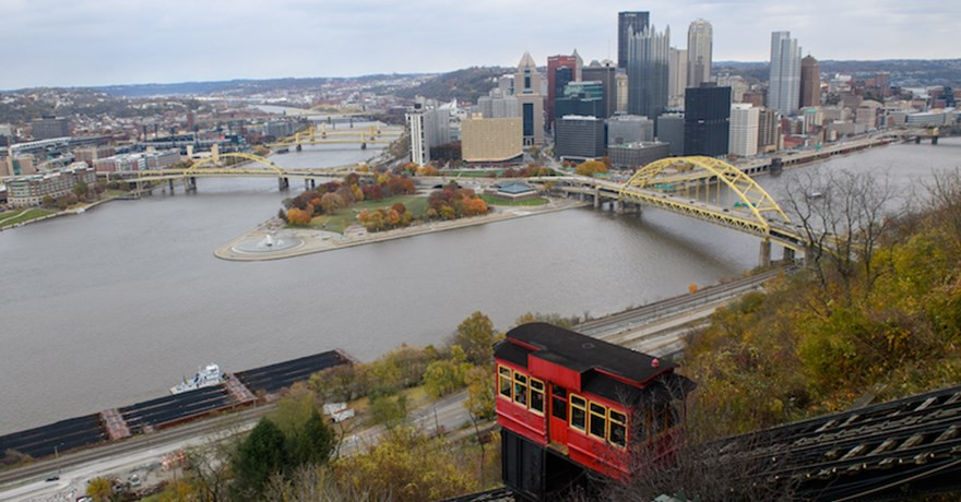 The Duquesne Incline overlooks the Three Rivers Heritage Trail and downtown Pittsburgh, offering stunning city views.