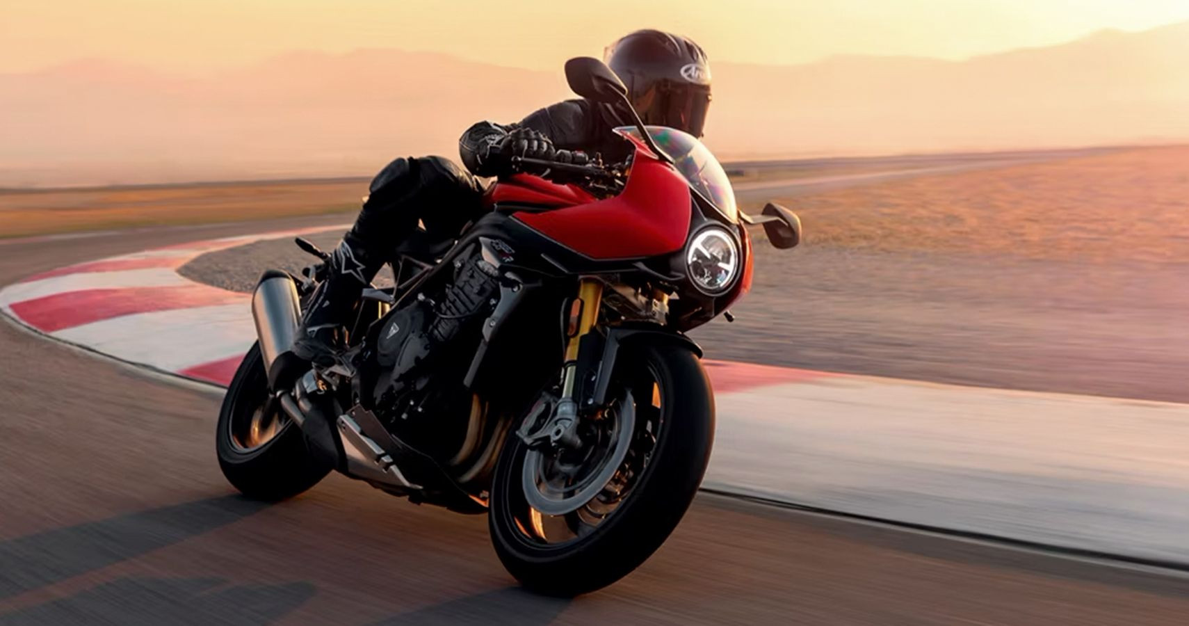 Triumph Speed Triple 1200 RR in red and black, on a racetrack and highlighting its classic yet sporty British design