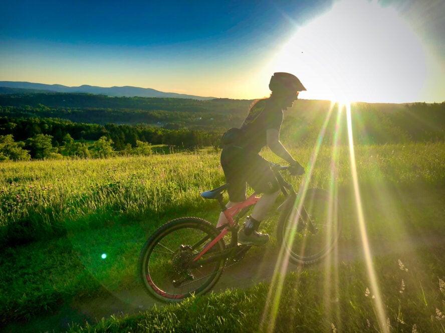 A scenic view of Vermont mountain biking trails, highlighting the natural beauty and accessible terrain suitable for beginner mountain bikers.