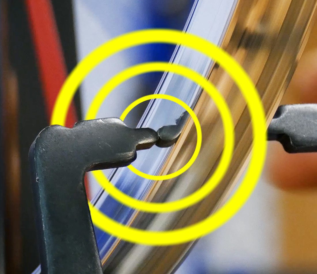 Truing stand making contact with sidewall of bicycle rim