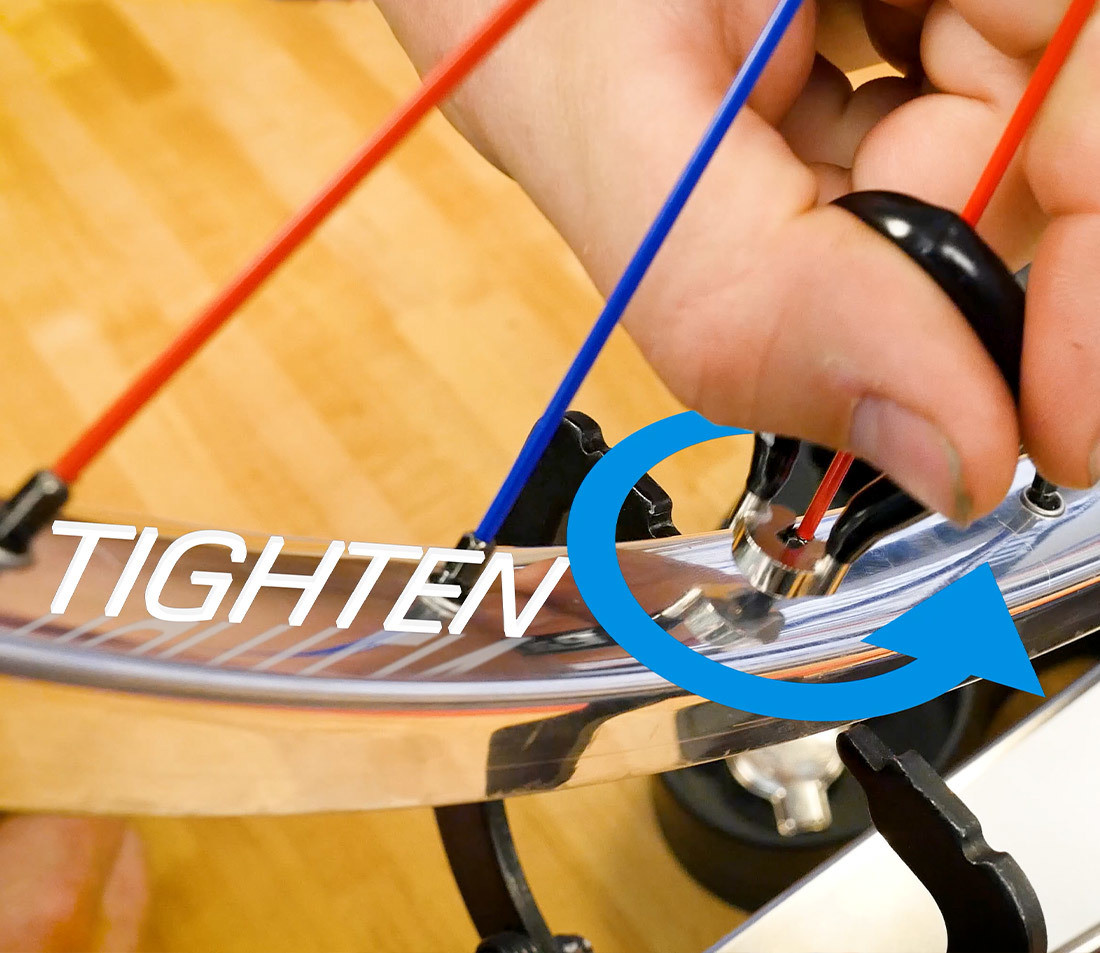 Perspective of tightening a spoke from above the rim