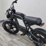 An electric bicycle with a rider on a sunny day