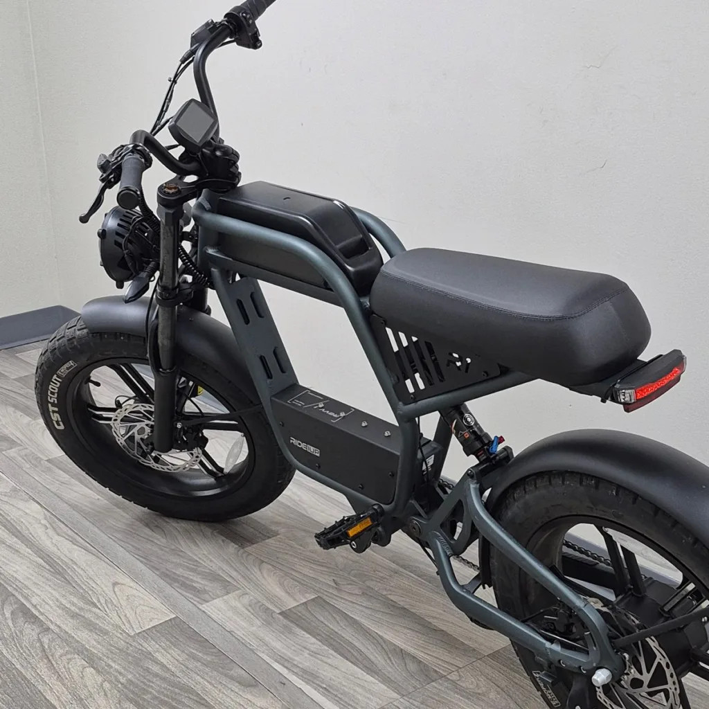 An electric bicycle with a rider on a sunny day
