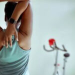 Woman on exercise bike focused on fitness