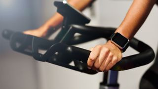 Hands on handlebars during stationary bike workout