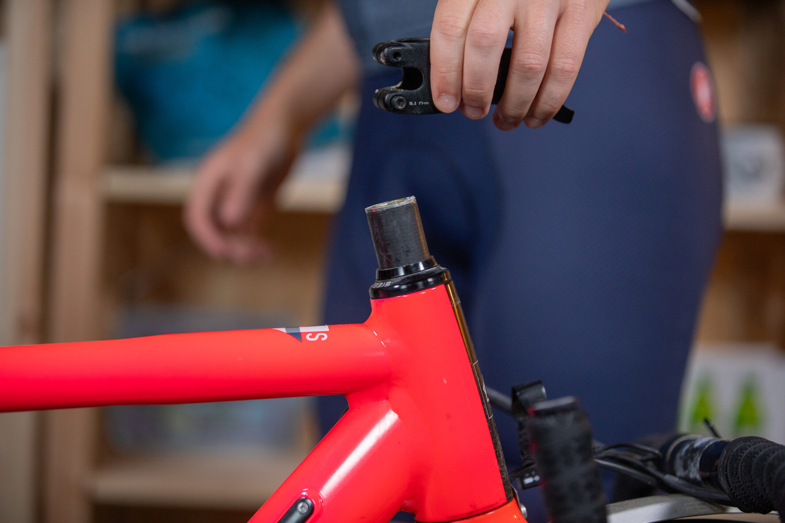 Liam Cahill holding stem over head tube of Kinesis road bike