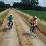 Couple riding a tandem bicycle on a sunny day