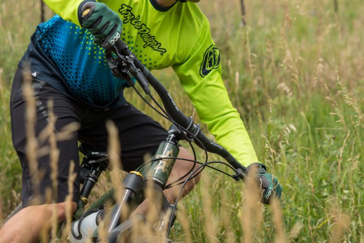 Hardtail mountain bike on a scenic trail, emphasizing its efficiency and lightweight design