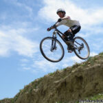 Mountain biker landing a drop