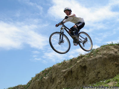 Mountain biker landing a drop