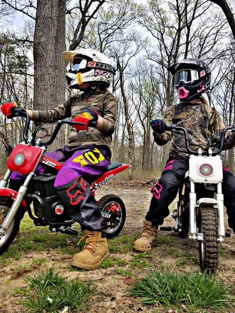 Two young dirt bike riders wearing motocross goggles, emphasizing the importance of eye protection