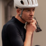 Man adjusting cycling helmet for a long ride