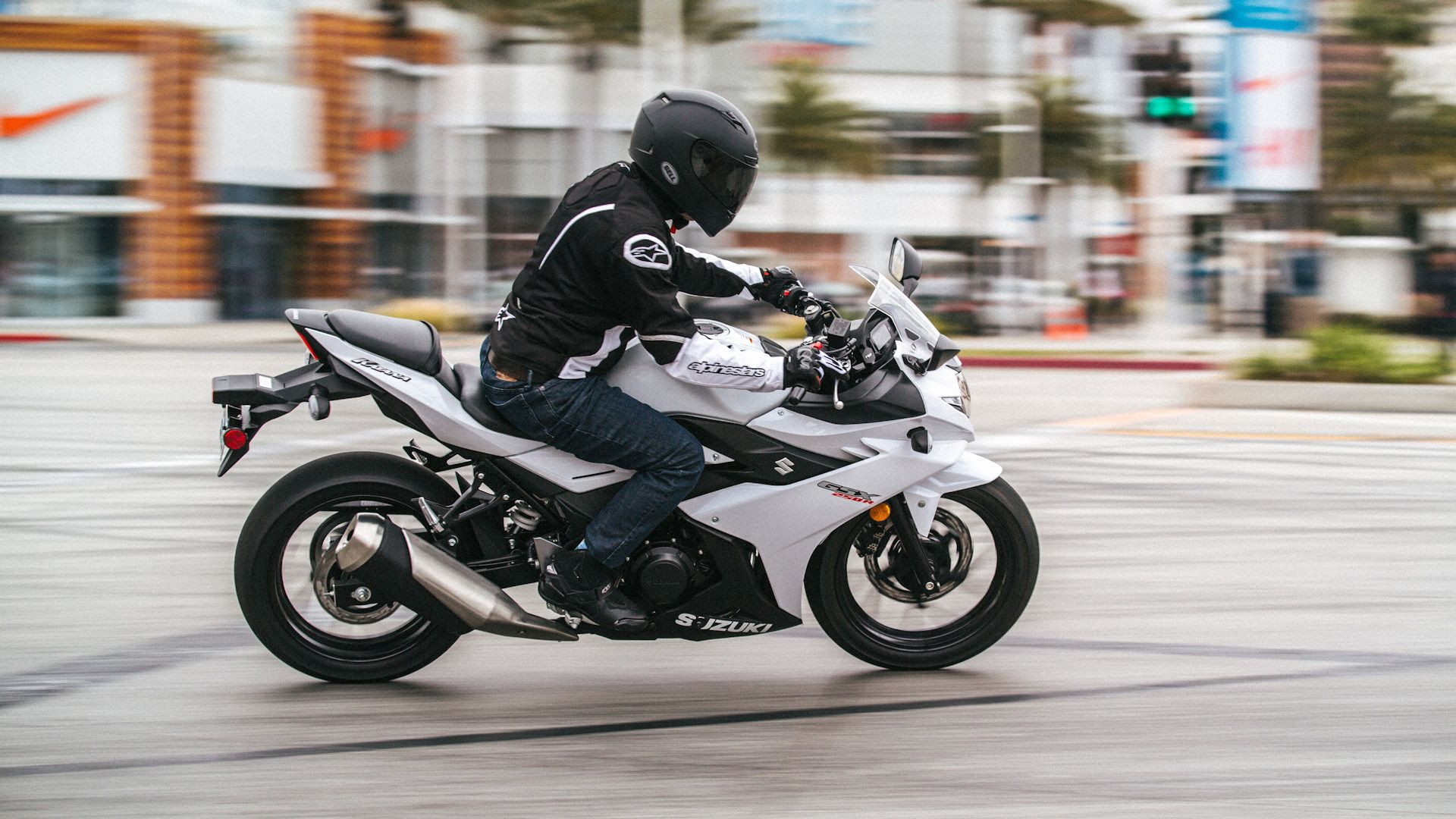 White Suzuki GSX250R cruising through town