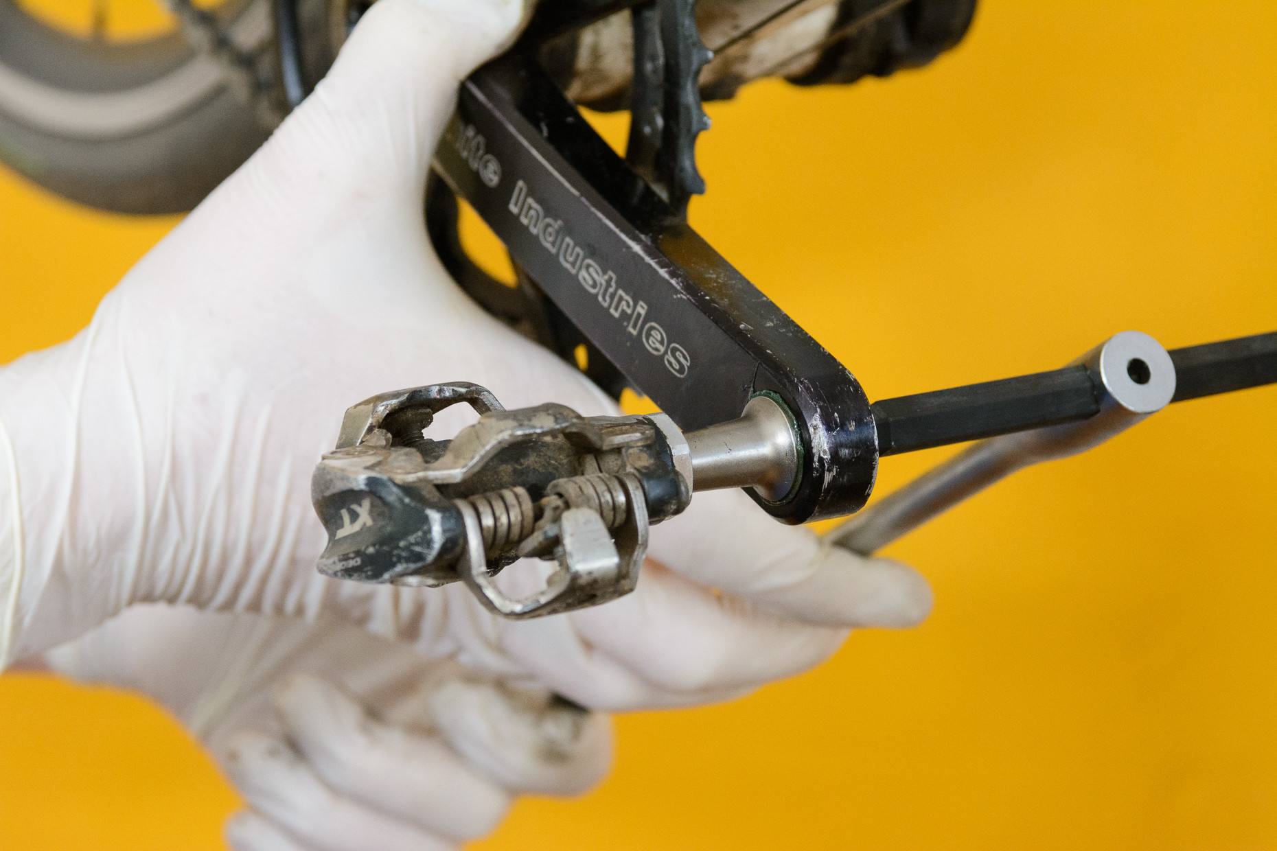 Tightening a bike pedal snugly against the crank arm
