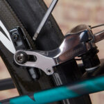 Worn brake pads on a road bike, indicating the need for replacement.