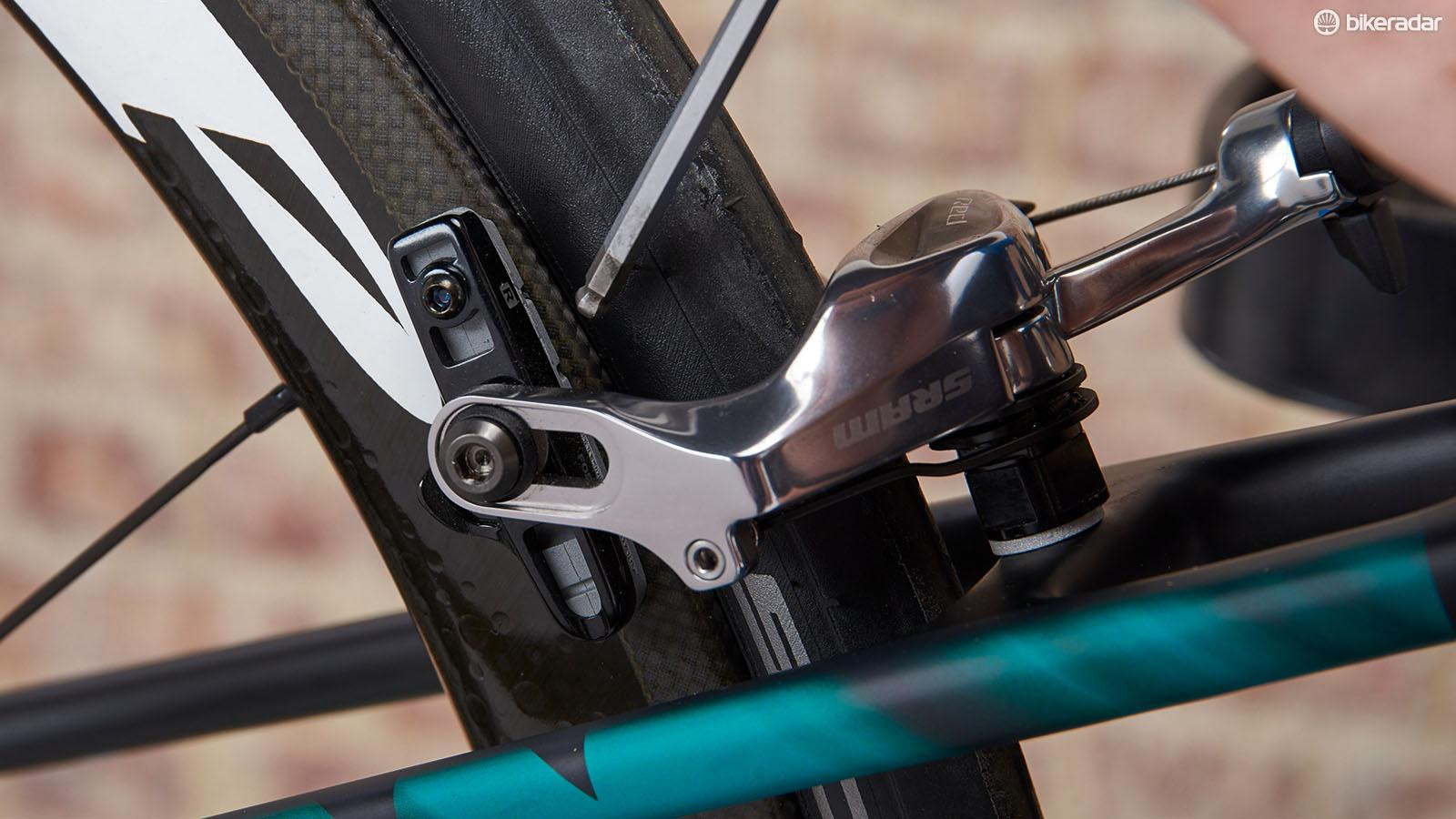 Worn brake pads on a road bike, indicating the need for replacement.