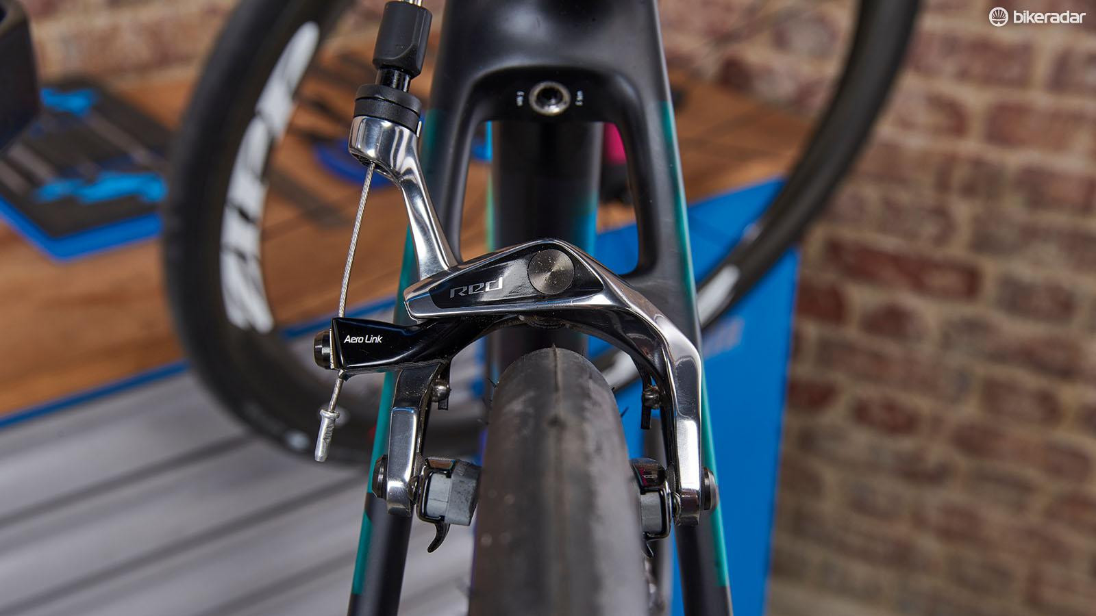 Close-up of brake calipers centered on a bike rim.