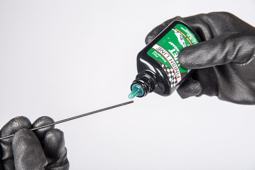 Inserting a new spoke through the hub of a motorcycle wheel