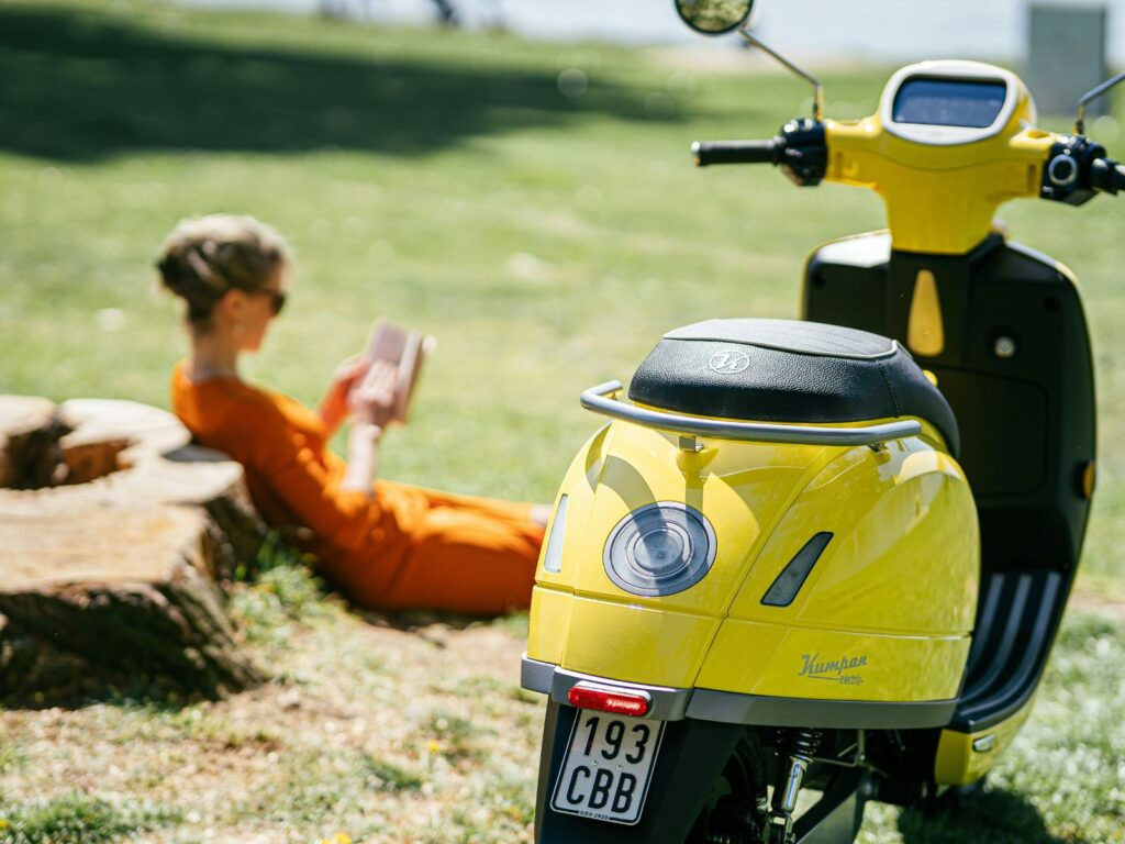 A rider on a 125cc motorcycle navigating city traffic