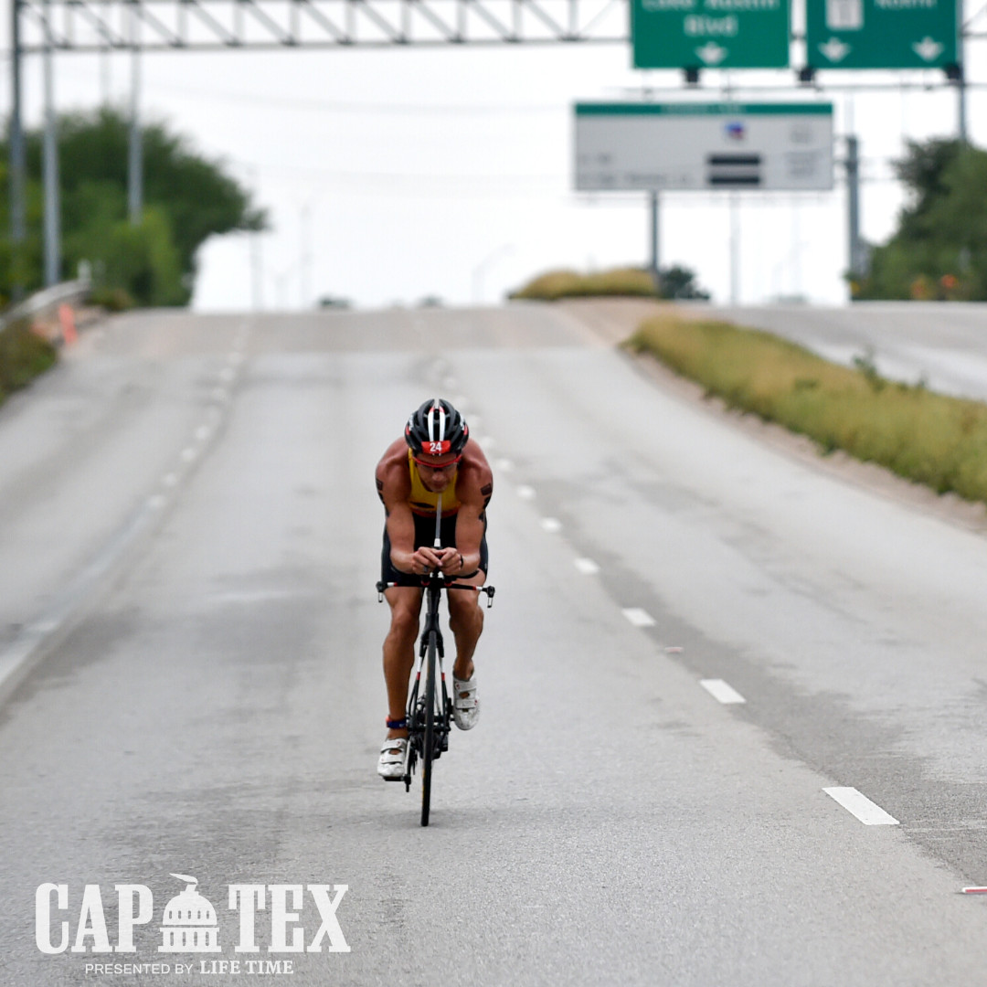 Cyclist wearing bright clothing and using lights for visibility.